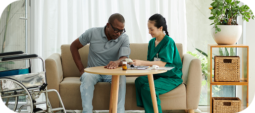 social-worker-checking-blood-pressure-patient-with-disability